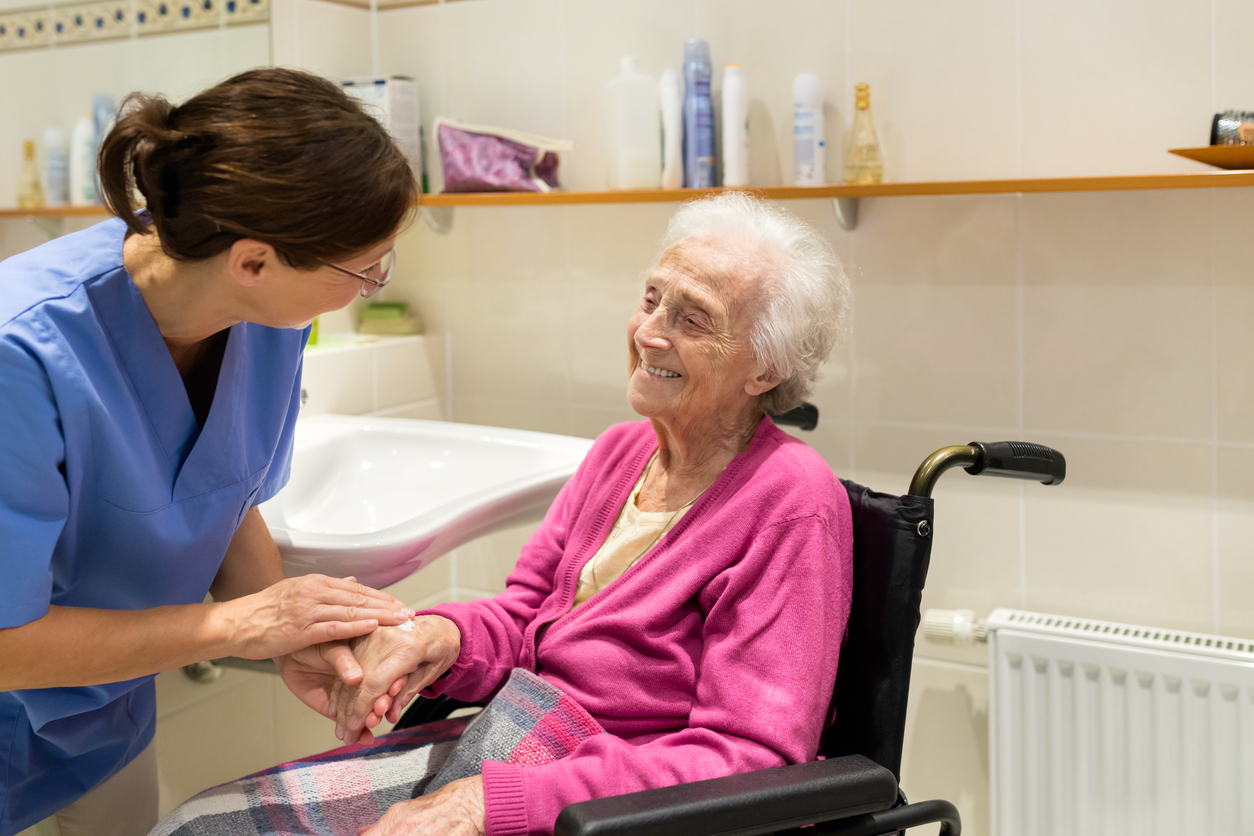 Home Caregiver with senior woman in bathroom